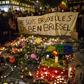 People hold a banner reading in French and Flamish "I AM BRUSSELS" as they gather around tributes for the victims of the Brussels bomb attacks March 22, 2016