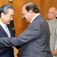 Pakistani President Mamnoon Hussain (R) shakes hands with Chinese Foreign Minister Wang Yi upon his arrival in Islamabad