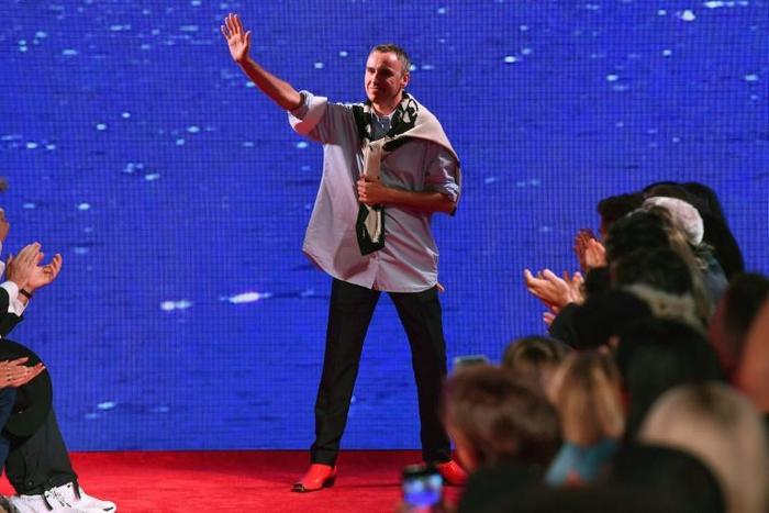 Belgian fashion designer Raf Simons waves to his guests, on the runway during New York Fashion Week in September 2018