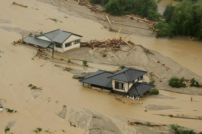 This aerial view shows homes flooded and buried in dirt in the city of Asakura, Fukuoka prefecture, on July 6, 2017