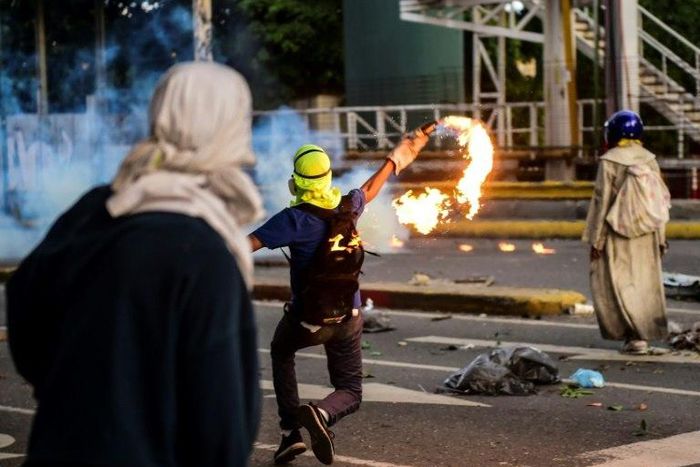 Opposition activists clash with the police in Caracas during a protest against Venezuelan President Nicolas Maduro