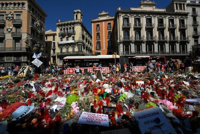People display flowers and candles to pay tribute to the victims of the Barcelona and Cambrils attacks on the Rambla boulevard in Barcelona on August 22, 2017, five days after the attacks that killed 15 people.