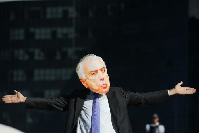 Protesters wearing masks of Brazilian leaders including President Michel Temer demonstrated in front of the Supreme Electoral Court in Brasilia on Wednesday