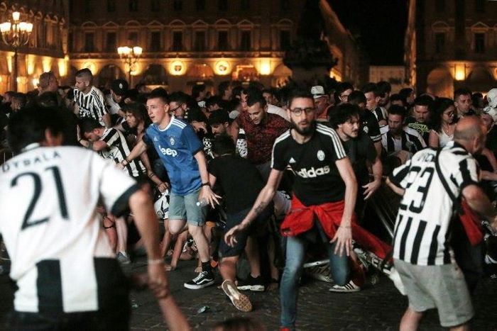 (FILES) This file photo taken on June 04, 2017 shows Juventus' supporters evacuating the Piazza San Carlo after a panic movement in the fanzone where thousands of Juventus fans watched the UEFA Champions League Final football match between Juventus and...