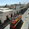 Tourists ride on a sightseeing bus in Arequipa, 1,600 km south of Lima