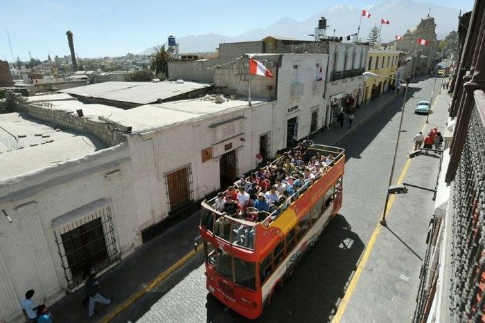 Tourists ride on a sightseeing bus in Arequipa, 1,600 km south of Lima