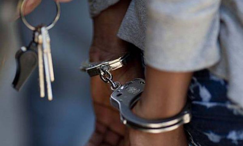 A woman in handcuffs