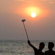 A Sri Lankan man takes a selfie on the beach in the Colombo