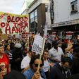 Protesters march along Notting Hill Gate after a gathering at Kensington Town Hall on June 16, as they demand justice for those affected by the fire that gutted Grenfell Tower