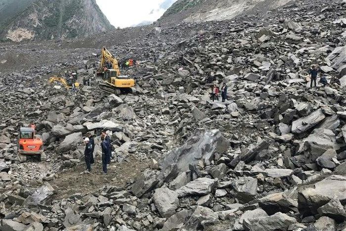 A couple and a baby were rescued and taken to hospital after 46 homes in the Chinese village of Xinmo were swallowed when the side of a mountain collapsed