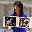US Ambassador to the UN Nikki Haley holds photos of victims as the UN Security Council meets in an emergency session in April about a suspected deadly chemical attack that killed civilians, including children, in Syria