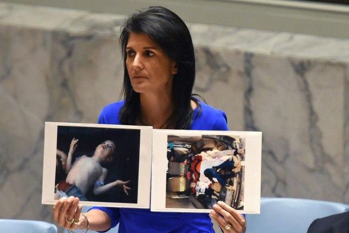 US Ambassador to the UN Nikki Haley holds photos of victims as the UN Security Council meets in an emergency session in April about a suspected deadly chemical attack that killed civilians, including children, in Syria