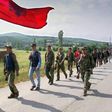 Kosovo Liberation Army (KLA) fighters marching down the mountains towards the Kosovar city of Lapusnik 17 June 1999