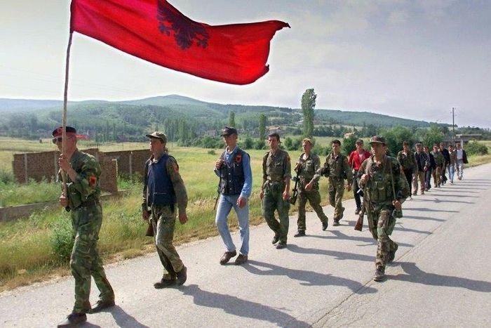 Kosovo Liberation Army (KLA) fighters marching down the mountains towards the Kosovar city of Lapusnik 17 June 1999