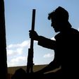 A member of the Syrian Democratic Forces holds a weapon in the Al-Senaa neighbourhood of Raqa on June 21, 2017