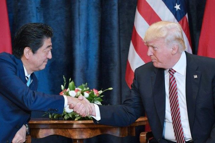 US President Donald Trump shakes hands with Japanese Prime Minister Shinzo Abe during a meeting before the G7 summit in Taormina, Italy, on May 26, 2017