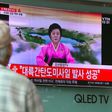 People watch a television news broadcast showing a North Korean announcer reading a statement on the country's new ICBM test, at a railway station in Seoul on July 4, 2017