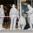 Police investigator work at the area around a supermarket in the northern German city of Hamburg, where a man killed one person in a knife attack, on July 28, 2017