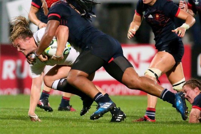 England's Sarah Bern (L) is tackled by France's Safi N'Diaye during the Women's Rugby World Cup 2017 semi-final match on August 22, 2017