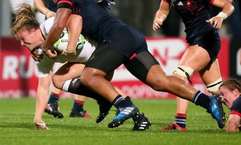 England's Sarah Bern (L) is tackled by France's Safi N'Diaye during the Women's Rugby World Cup 2017 semi-final match on August 22, 2017