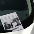 A flyer for a missing person Khadija Saye pictured on a car near a temporary casualty bureau opened for people affected by the fire at Grenfell Tower, a residential block of flats in west London, on June 14, 2017