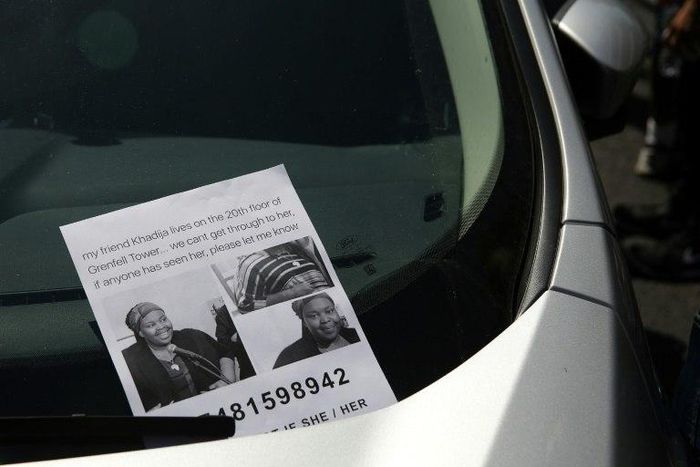 A flyer for a missing person Khadija Saye pictured on a car near a temporary casualty bureau opened for people affected by the fire at Grenfell Tower, a residential block of flats in west London, on June 14, 2017