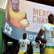 Guinea's players wearing tee-shirts with a picture of Cheick Tiote enter the stadium under a poster reading, "Thank you Champion'' prior to the start of the 2019 African Cup of Nations qualifier football match in Bouake on June 10, 2017