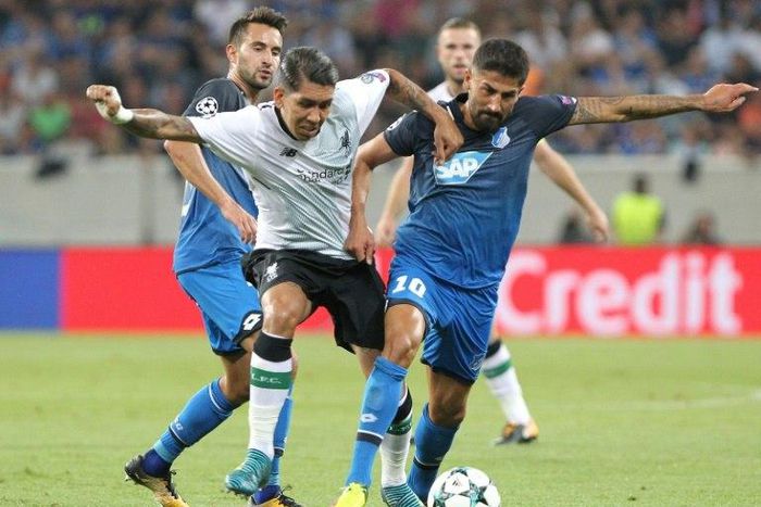 Hoffenheim midfielder Kerem Demirbay (R) grapples with Liverpool midfielder Roberto Firmino during the Champions League qualifier first leg in Sinsheim, Germany, on August 15, 2017