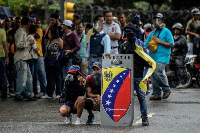 Opposition demonstrators block an avenue during an anti-government protest, in Caracas on June 29, 2017