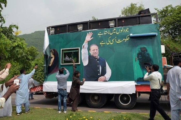Pakistani supporters of deposed prime minister Nawaz Sharif gather around a container prepared for the rally led by Sharif in Islamabad