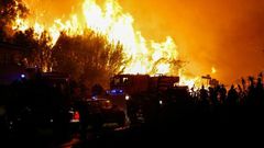 Firefighters work to put out a fire in Biguglia, on the French Mediterranean island of Corsica