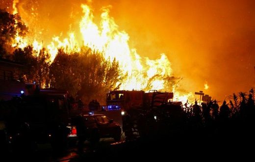 Firefighters work to put out a fire in Biguglia, on the French Mediterranean island of Corsica