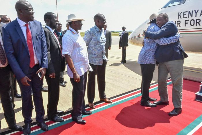 President Uhuru Kenyatta hugs ODM leader Raila Odinga