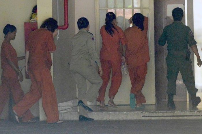 Police said Tammy Davis-Charles (2nd L) moved to Cambodia to take advantage of the continued demand for surrogates, charging Australian clients up to $50,000 for each request