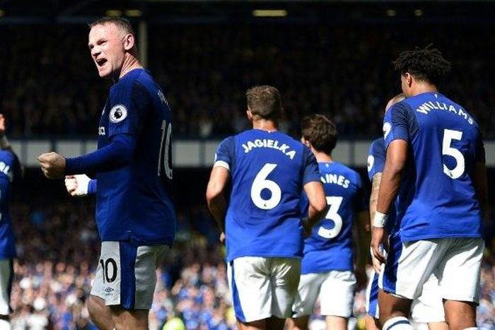 Everton's English striker Wayne Rooney (C) celebrates scoring the opening goal during the English Premier League football match between Everton and Stoke City at Goodison Park in Liverpool, north west England on August 12, 2017