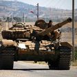 Opposition fighters drive a tank in Syria's southwestern Quneitra province in June 2017