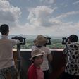 Tourists look out towards North Korea at an observation point within the Demilitarized Zone separating North and South Korea