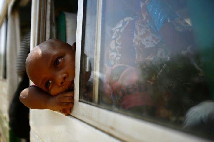 Migrants from Eritrea sit on a bus at the al-Laffa border crossing in Sudan's eastern Kassala state on the Eritrea-Sudan border on May 2, 2017