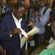 Kenya's opposition alliance, National Super Alliance (NASA) presidential candidate, Raila Odinga prepares to cast his ballots on August 8, 2017 mobbed by a battery of photo journalists at Old-Kibera primary school polling centre, in Nairobi