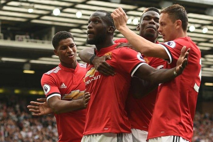 Manchester United's Romelu Lukaku celebrates with teammates after scoring a goal during their English Premier League match against West Ham United, at Old Trafford in Manchester, on August 13, 2017