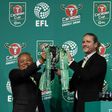 CEO of Carabao Group Sathien Setthasit (L) and former French international footballer Emmanuel Petit raise the EFL Carabao Cup after the first draw for the upcoming season's EFL Cup tournament, at Tawandaeng brewery in Bangkok, on June 16, 2017
