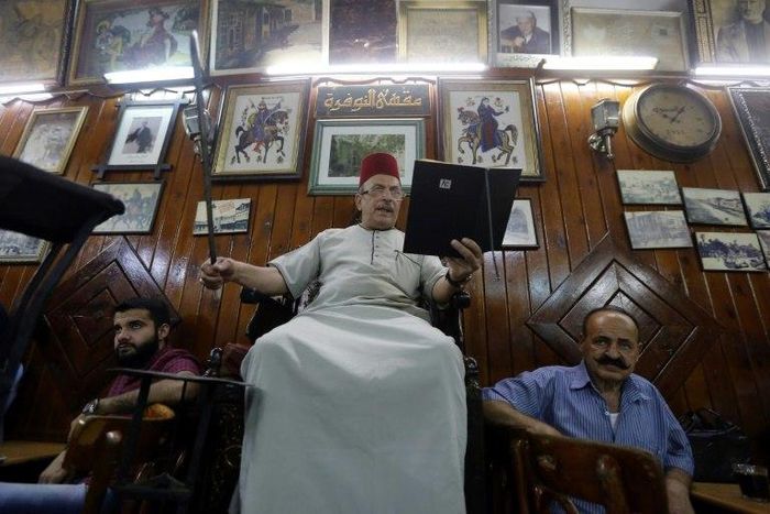 Ahmad al-Lahham (C) says tales of courage and conquest have become more popular since the Syria war broke out in 2011