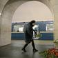 A woman places flowers in honour of the victims of the April 3 blast on the platform of Technological Institute metro station in Saint Petersburg on April 4, 2017