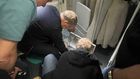 Russian Health Minister Mikhail Murashko attending to a passenger's emergency