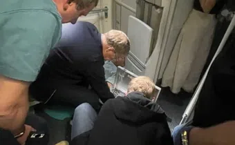 Russian Health Minister Mikhail Murashko attending to a passenger's emergency