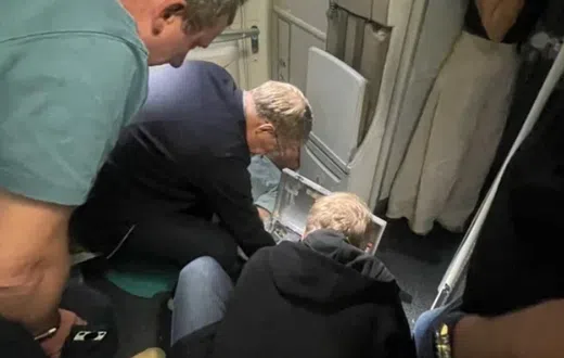 Russian Health Minister Mikhail Murashko attending to a passenger's emergency