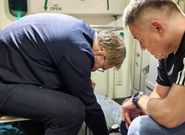 Russian Health Minister Mikhail Murashko attending to a passenger's emergency