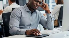 An AI-generated image of a person sad in a work place