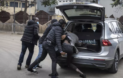 Plainclothes officers arrest a man in Nairobi, Kenya