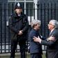 European Commission President Jean-Claude Juncker (R) is greeted by British Prime Minister Theresa May outside 10 Downing Street in London